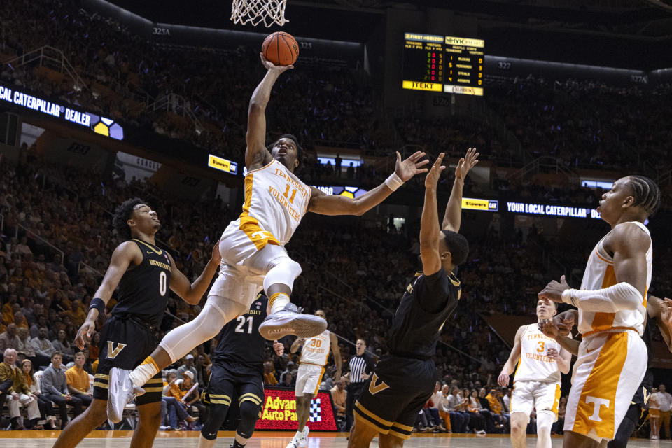 Tennessee forward Tobe Awaka (11) shoots from between Vanderbilt guard Tyrin Lawrence (0) and Isaiah West (4) during the first half of an NCAA college basketball game Saturday, Feb. 17, 2024, in Knoxville, Tenn. (AP Photo/Wade Payne)
