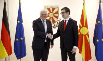 German President Frank-Walter Steinmeier, left, shakes hands with North Macedonia's President Stevo Pendarovski, right, upon his arrival in the presidential palace in Skopje, North Macedonia, on Tuesday, Nov. 29, 2022. German President Steinmeier is on a two-day official visit to North Macedonia. (AP Photo/Boris Grdanoski)