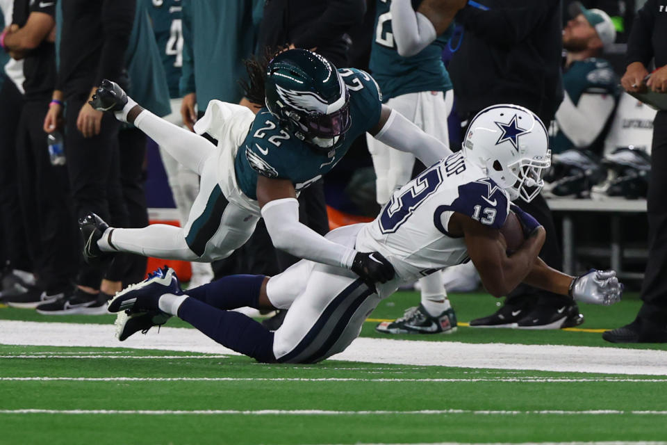 ARLINGTON, TEXAS – DECEMBER 10: Michael Gallup #13 of the Dallas Cowboys is tackled by Kelee Ringo #22 of the Philadelphia Eagles after a reception during the fourth quarter at AT&T Stadium on December 10, 2023 in Arlington, Texas. (Photo by Richard Rodriguez/Getty Images)