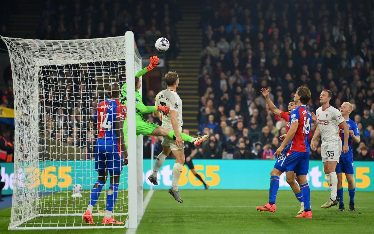 Dean Henderson of Crystal Palace is fouled by Rasmus Hojlund of Manchester United