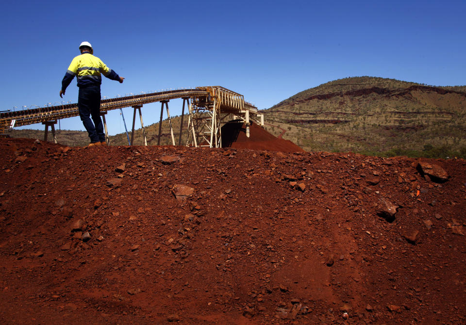 Fortescue Chief Executive Officer (CEO) Nev Power climbs a pile of iron ore at the Fortescue Solomon iron ore mine located in the Valley of the Kings, around 400 km (248 miles) south of Port Hedland in the Pilbara region of Western Australia December 2, 2013. Australian iron ore mining seems immune from the spending crunch afflicting other commodities as a slowdown in Chinese growth cools a decade-long mining boom. Rio Tinto, BHP Billiton and Fortescue Metals Group are bulking up in Western Australia's iron-rich Pilbara desert as if the mining boom had never ended. A place where capital expenditure is still measured in the billions. The miners are speeding up transformation of an area the size of Peru into a moonscape of rust-red pits linked via thousands of kilometres (miles) of rail lines to giant iron ore ports perched on the easternmost edge of the Indian Ocean. Picture taken December 2, 2013. REUTERS/David Gray     (AUSTRALIA - Tags: BUSINESS COMMODITIES)