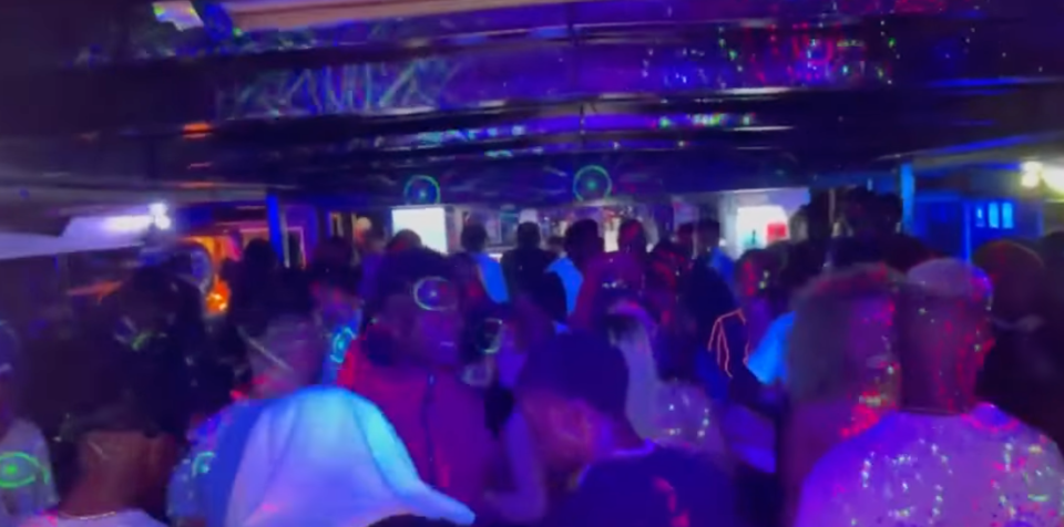 Video from the boat party shows dozens mingling on the dance floor. Source: Nine