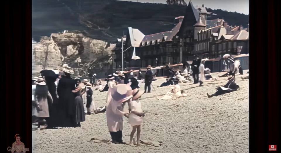 A group of Parisians stand on the beach in 1899. 