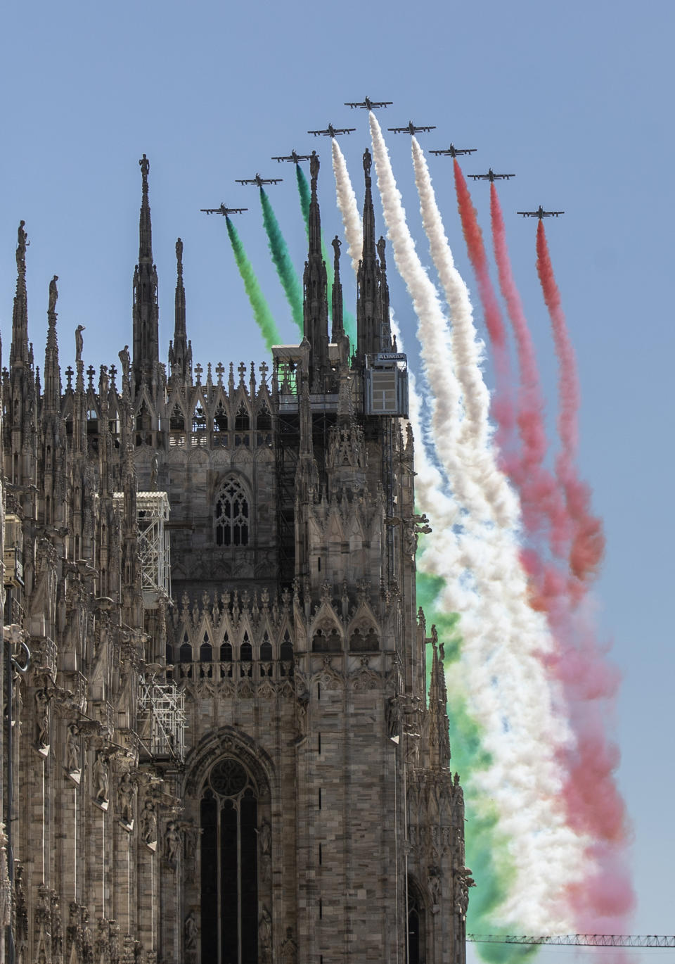 The Frecce Tricolori aerobatic squad of the Italian Air Force flies over Milan's Duomo cathedral, northern Italy, Monday, May 25, 2020 on the occasion of the 74th anniversary of the founding of the Italian Republic on June 2, 1946. This year the acrobatic squad will fly over several Italian cities to bring a message of unity and solidarity during the coronavirus pandemic.(AP Photo/Luca Bruno)