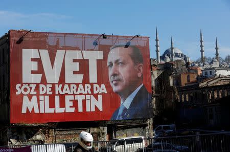 A billboard carrying a picture of Turkish President Tayyip Erdogan and a slogan that reads: "Yes. It is for the people to speak and to decide" is seen on a building ahead of the constitutional referendum in Istanbul, Turkey April 13, 2017. REUTERS/Murad Sezer - RTX35F8G