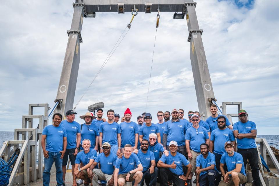 A picture shows Loeb and the team of his interstellar expedition to Papua New Guinea on the boat. They are all wearing blue shirts