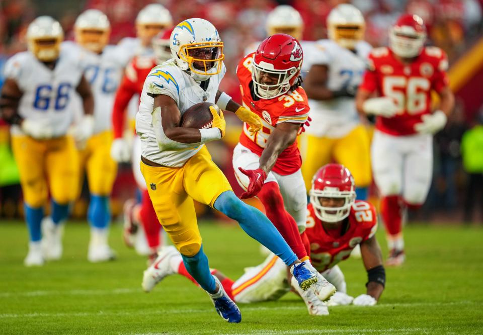 Los Angeles Chargers wide receiver Joshua Palmer (5) runs with the ball against Kansas City Chiefs cornerback L'Jarius Sneed (38) during the second half at GEHA Field at Arrowhead Stadium.