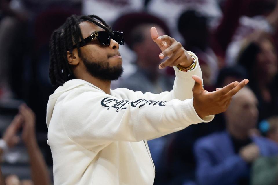 Injured Cleveland Cavaliers guard Darius Garland cheers on the team from the bench during the first half of a NBA basketball game against the Washington Wizards, Sunday, Oct. 23, 2022, in Cleveland. (AP Photo/Ron Schwane)