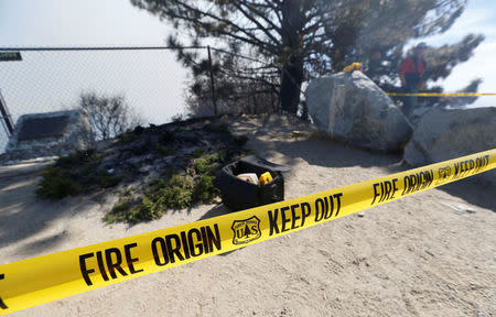 Yellow tape is seen by the fire origin spot during the Wilson Fire near Mount Wilson in the Angeles National Forest in Los Angeles, California, U.S. October 17, 2017. REUTERS/Mario Anzuoni