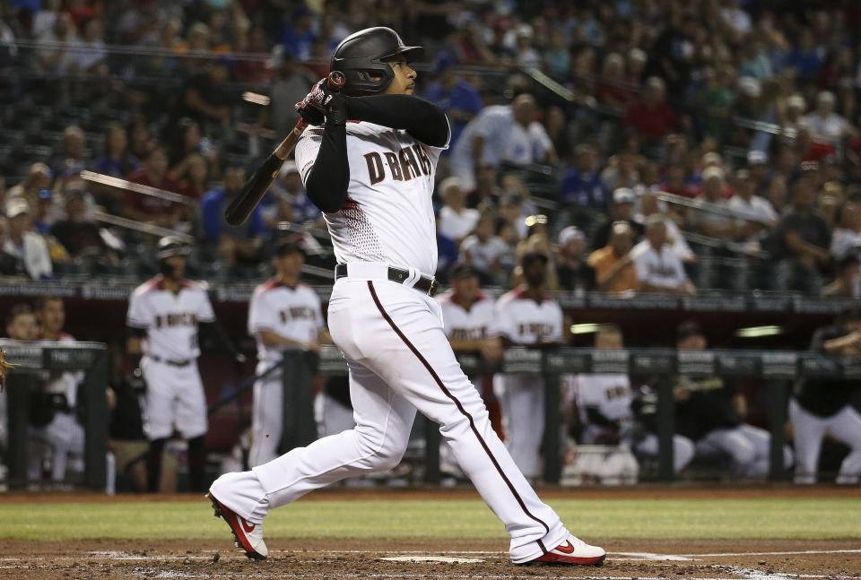 Arizona Diamondbacks' Eduardo Escobar watches the flight of his three-run home run against the Los Angeles Dodgers during the first inning of a baseball game Wednesday, June 26, 2019, in Phoenix. (AP Photo/Ross D. Franklin)