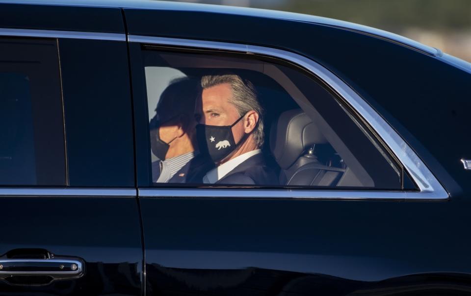 Two people in the back of a car.