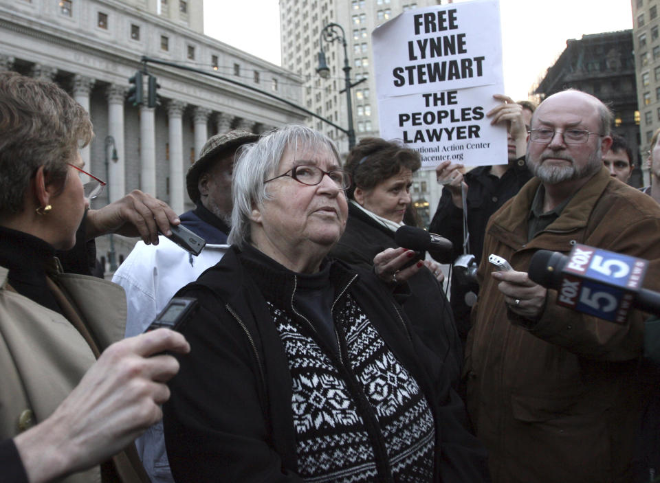 FILE - In this Nov. 17, 2009, file photo, Lynne Stewart, center, is surrounded by supporters and reporters in New York after a federal appeals court in New York City said a judge who sentenced Stewart to just over two years in prison should consider a harsher sentence in light of her case's terrorism connection. It can be an uncomfortable life for any defense attorney representing unpopular clients, but lawyers who agree to speak on behalf of people accused of plotting to kill Americans in terrorist attacks walk difficult road. Stewart was an attorney for a blind Egyptian sheik serving life for terrorism convictions until she was arrested on terrorism charges months after 9/11 for letting him communicate with followers. (AP Photo/Mary Altaffer, File)