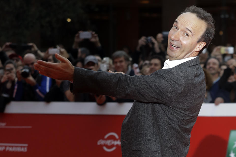 FILE - In this Sunday, Oct. 23, 2016 filer, Roberto Benigni poses for photographers as he arrives on the red carpet at the Rome Film Festival. The Venice Film Festival said Thursday, April 15, 2021 it will give its lifetime achievement award this year to Oscar-winning director and actor Roberto Benigni. The Golden Lion for Lifetime Achievement is to be awarded at 78th edition of the world’s oldest film festival, scheduled for Sept. 1-11 on the Lido. Benigni wrote, directed and starred in “La Vita e Bella,” (“Life is Beautiful”), which won the Oscar for best foreign language film, best actor and best musical score in 1999. (AP Photo/Gregorio Borgia, File)