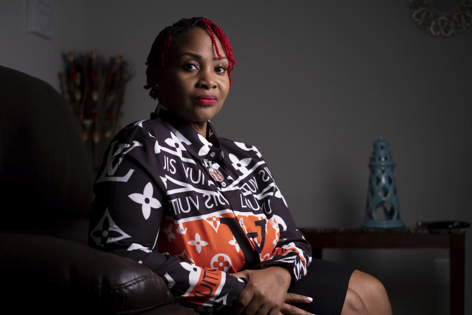 Ebony Brown, whose brother was shot and killed in 2002, poses for a photo in McDonough, Ga., on Aug. 29, 2022. Brown doesn't consider herself a gun lover, but the mother of two is considering purchasing a pistol for protection in case she is ever threatened with a gun. (AP Photo/Ben Gray)