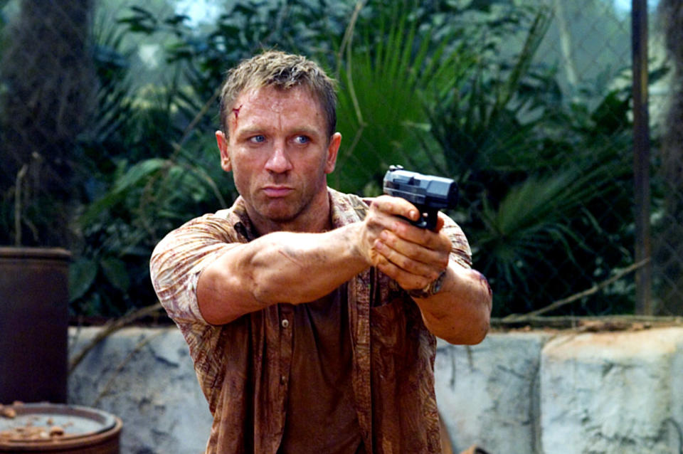 Daniel Craig pointing a gun.