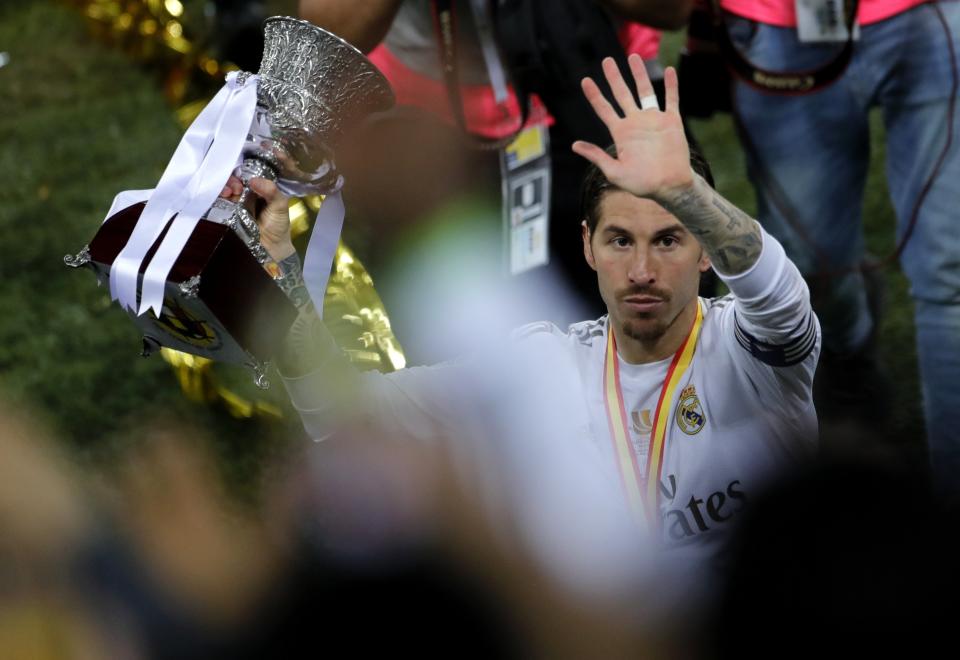 Real Madrid's Sergio Ramos celebrates with the trophy after they beat Atletico Madrid in the Spanish Super Cup Final soccer match at King Abdullah stadium in Jiddah, Saudi Arabia, Monday, Jan. 13, 2020. (AP Photo/Amr Nabil)