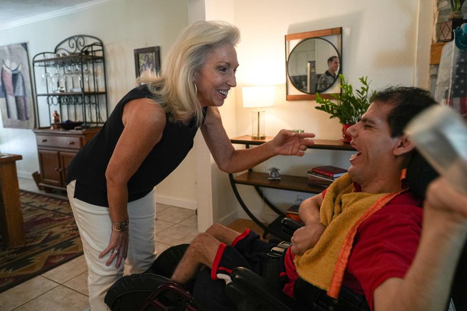 Phyllis Campos plays with her son Cody. She keeps herself strong to be able to lift him.