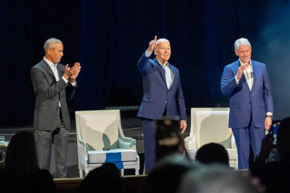 President Joe Biden, center, and former presidents Barack Obama, left, and Bill Clinton participate in a fundraising event with Stephen Colbert at Radio City Music Hall, Thursday, March 28, 2024, in New York (AP)