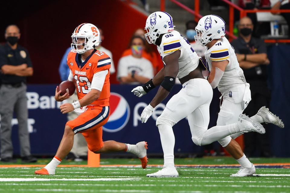 Sep 18, 2021; Syracuse, New York, USA; Syracuse Orange quarterback Tommy DeVito (13) runs with the ball as Albany Great Danes defensive lineman Jared Verse (96) and linebacker AJ Mistler (41) defend during the first half at the Carrier Dome. Mandatory Credit: Rich Barnes-USA TODAY Sports