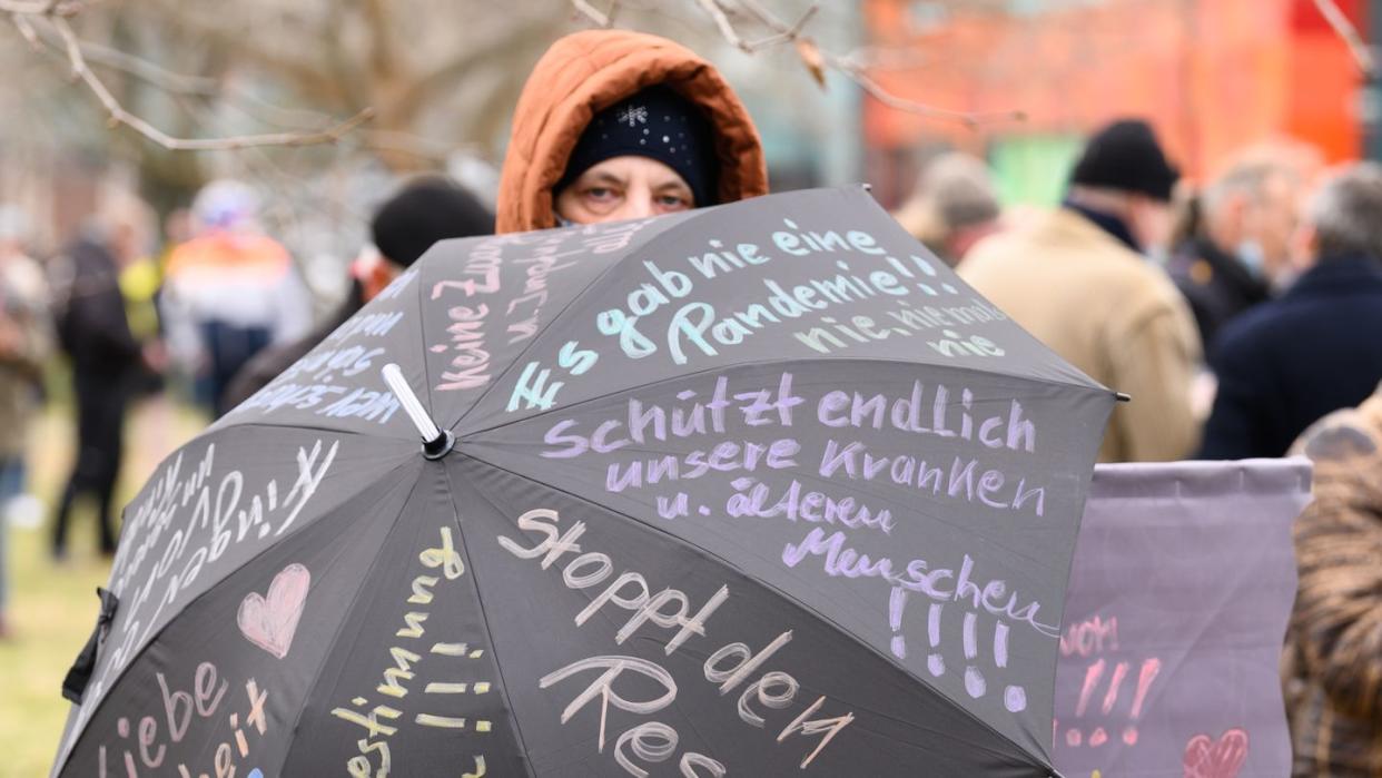 Eine Teilnehmerin der Proteste in Dresden hat ihre Forderungen auf einen Regenschirm geshrieben.