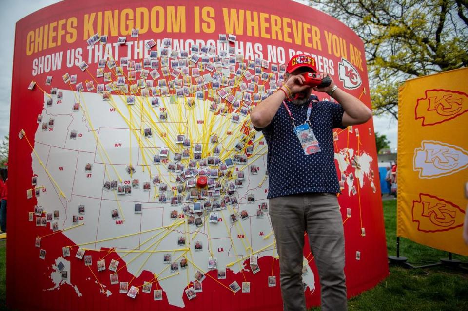 A Kansas City Chiefs employee takes a Polaroid photo of fans at the Chiefs Kingdom Experience exhibit during the NFL Draft on Thursday, April 27, 2023, in Kansas City. Chiefs fans were given the opportunity to place the photos on a map depicting where they traveled from around the world. 