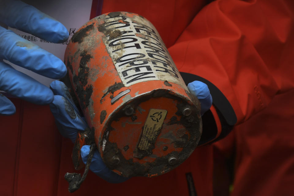 FILE - In this photo released by Xinhua News Agency, a search and rescue worker holds the second orange-colored "black box" recorder which recovered at the China Eastern flight crash site in Tengxian County in southern China's Guangxi Zhuang Autonomous Region on March 27, 2022. Two years after a Boeing 737-800 passenger jet crashed on a domestic flight in China, killing all 132 people on board, accident investigators indicated Wednesday, March 20, 2024 that they have not yet determined the cause. (Lu Boan/Xinhua via AP, File)