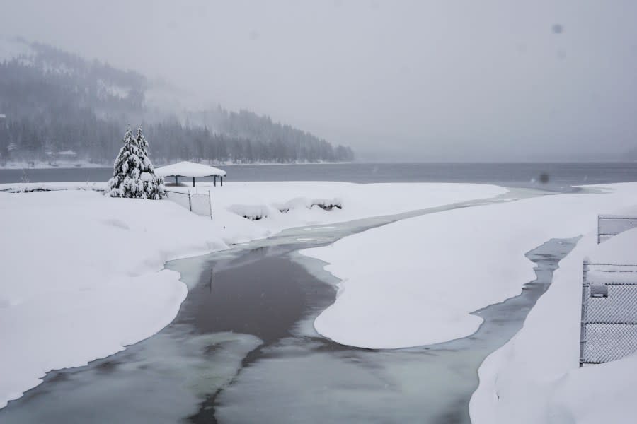 Snow covers the shore on Donner Lake, Saturday, March 2, 2024, in Truckee, Calif. A powerful blizzard howled Saturday in the Sierra Nevada as the biggest storm of the season shut down a long stretch of Interstate 80 in California and gusty winds and heavy rain hit lower elevations, leaving tens of thousands of homes without power. (AP Photo/Brooke Hess-Homeier)