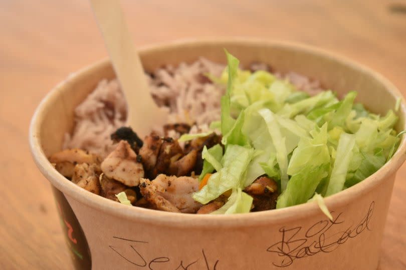 Jerk Chicken box with salad and rice and peas