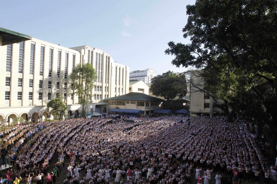 Thousands of students and faculty members dance to the theme song of the One Billion Rising campaign in the quadrangle of the St. Scholastica college in Manila February 14, 2013. One Billion Rising is a global campaign to call for an end to violence against women and girls, according to its organisers. REUTERS/Romeo Ranoco (PHILIPPINES - Tags: POLITICS SOCIETY EDUCATION)