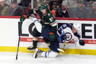 Minnesota Wild's Kirill Kaprizov (97) sends Winnipeg Jets' Nate Schmidt (88) to the ice during the first period of an NHL hockey game Tuesday, Oct. 19, 2021, in St. Paul, Minn. (AP Photo/Jim Mone)