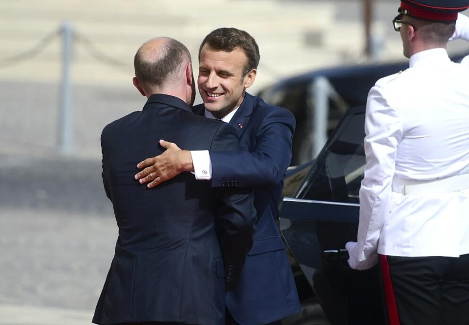 French President Emmanuel Macron, right, hugs Malta Prime Minister Joseph Muscat on the occasion of the Mediterranean Summit of Southern EU countries in Valetta, Malta, Friday, June 14, 2019. (AP Photo/Jonathan Borg)