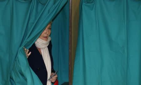 French National Front political party leader and candidate Marine Le Pen leaves the polling booth to cast her ballot during the first round of the regional elections in Henin-Beaumont, France, December 6, 2015. REUTERS/Pascal Rossignol