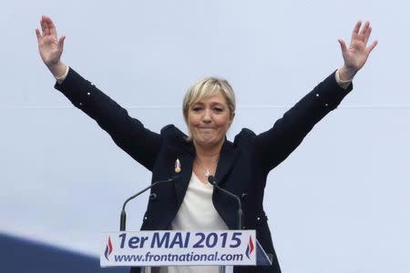 France's far-right National Front political party leader Marine Le Pen waves to the audience at the end of her speech during their traditional May Day tribute to Joan of Arc in Paris, France, May 1, 2015. REUTERS/Philippe Wojazer