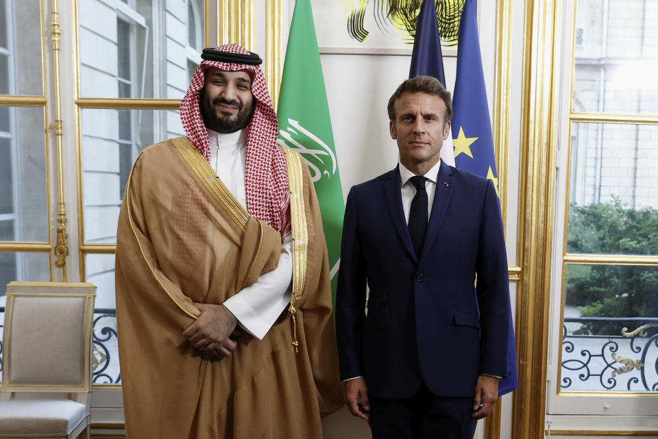 French President Emmanuel Macron welcomes Saudi Crown Prince Mohammed bin Salman for a dinner inside the Elysee Palace in Paris, Thursday July 28, 2022. (Benoit Tessier/Pool via AP)