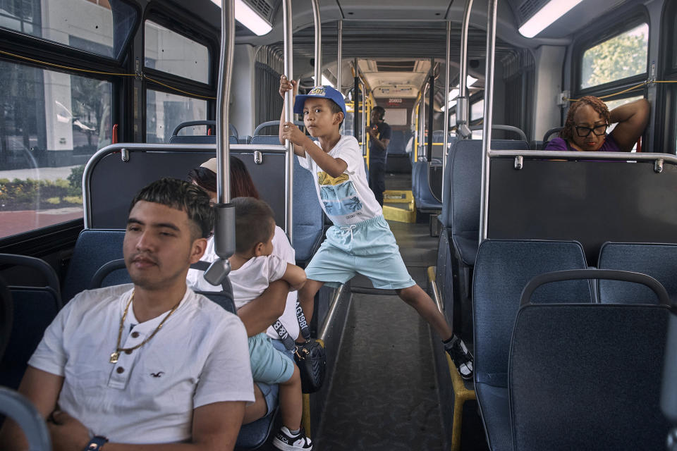 Migrant Darwin Salinas, 24, left, travels with his wife Kimberly Carchipulla, 23, second left, partly seen, and his sons Damien, 6, center, and Derek, 1, Sunday, June 16, 2024, near Newark, N.J. Thousands of migrant families in New York City are facing a summer of uncertainty for their school-aged children with a citywide limit of 60 days in a shelter before needing to reapply or find their own. (AP Photo/Andres Kudacki)