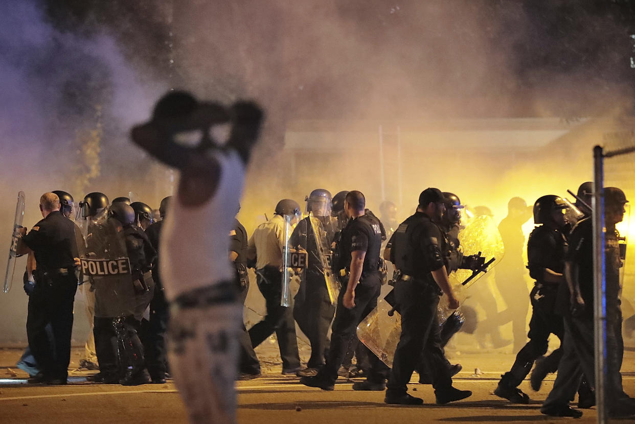 Police retreat under a cloud of tear gas as protesters disperse from the scene of a standoff after Frayser community residents took to the streets in anger against the shooting of a youth by U.S. Marshals earlier in the evening, Wednesday, June 12, 2019, in Memphis, Tenn. (Photo: Jim Weber/Daily Memphian via AP)