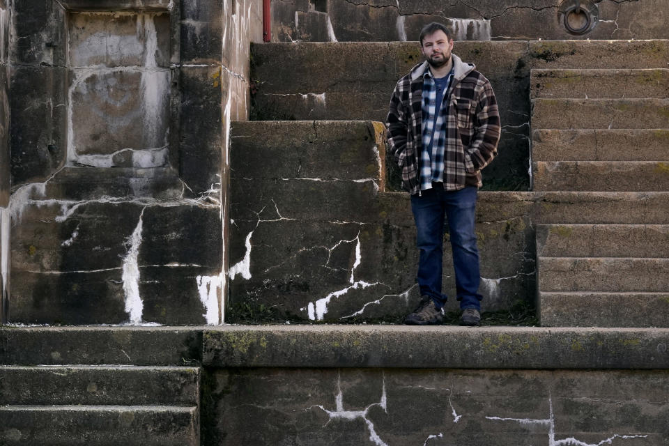 Jacob, an abuse survivor from New Hampshire’s youth detention center, stands for a portrait at Fort Foster, a place where he finds personal solace, Thursday, Nov. 30, 2023, in Kittery Point, Maine. He says he's frustrated that so few perpetrators have been held accountable. “I am at the point where I want the state to be responsible,” he said. “I want people to know.” (AP Photo/Charles Krupa)