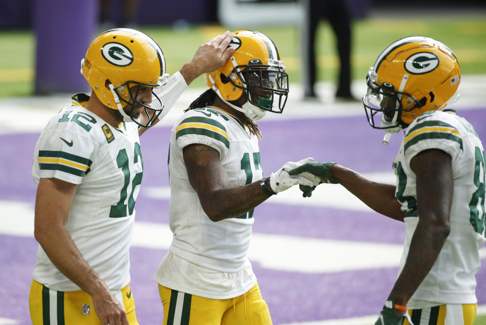 Green Bay Packers wide receiver Davante Adams, center, celebrates with teammates Aaron Rodgers, left, and Marquez Valdes-Scantling, right, after catching a 1-yard touchdown pass during the second half of an NFL football game against the Minnesota Vikings, Sunday, Sept. 13, 2020, in Minneapolis. (AP Photo/Bruce Kluckhohn)