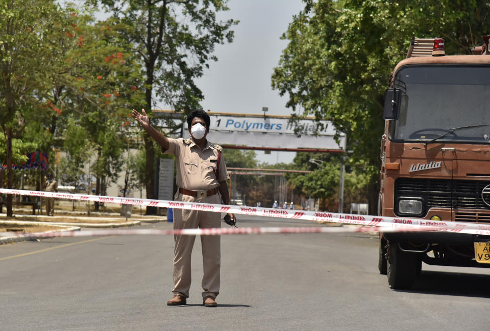 A policeman stands guard near the LG Polymers plant, the site of a chemical gas leak, in Vishakhapatnam, India, Friday, May 8, 2020. Indian authorities evacuated more people from villages near a South Korean-owned chemical factory where a gas leak killed 12 people and left about 1,000 struggling to breathe. Authorities said the evacuation was precautionary, but it triggered panic among people overnight that another gas leak was occurring. (AP Photo)