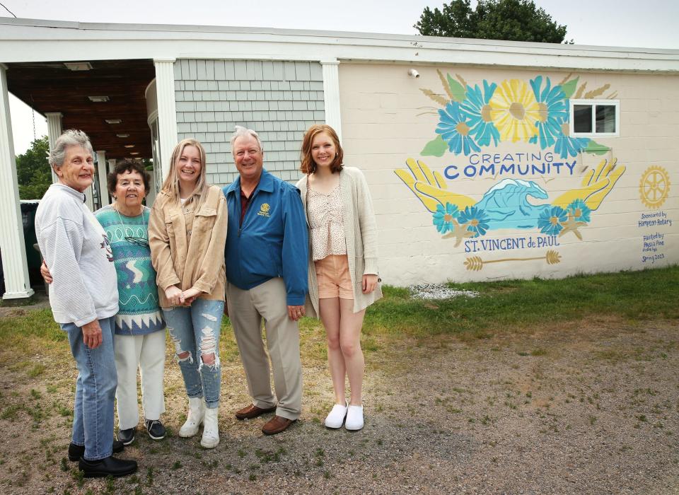 St. Vincent de Paul's Community Kitchen and Clothes Closet in Hampton has a new mural on the side of its building. From left are volunteers Marcia Sapienza, Peg Overlock, mural artist Alyssa Pine, Rotary member Geoff Merrill and volunteer Mary Winter.