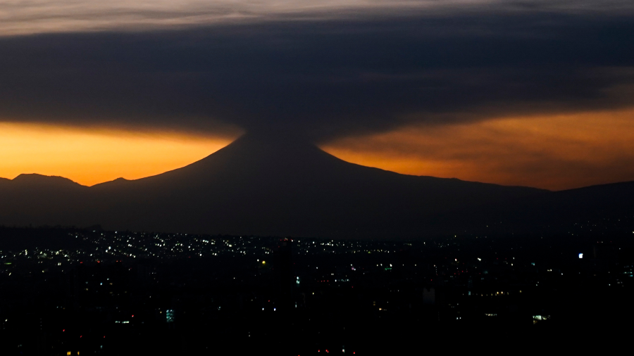 The Popocatepetl volcano emits smoke and ash, seen from Mexico City at sunrise on Tuesday, Feb. 27, 2024.