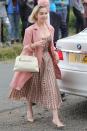 <p>Emilia Clarke opted for a ladylike printed dress with Dior pumps and a pink coat.</p>