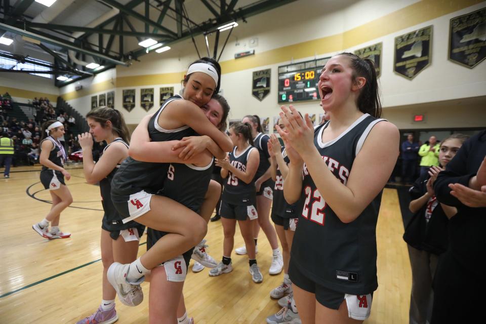 Canandaigua Academy's Mya Herman celebrates her team's victory with Liv Schorr while teammate Julia Geitner applauds.