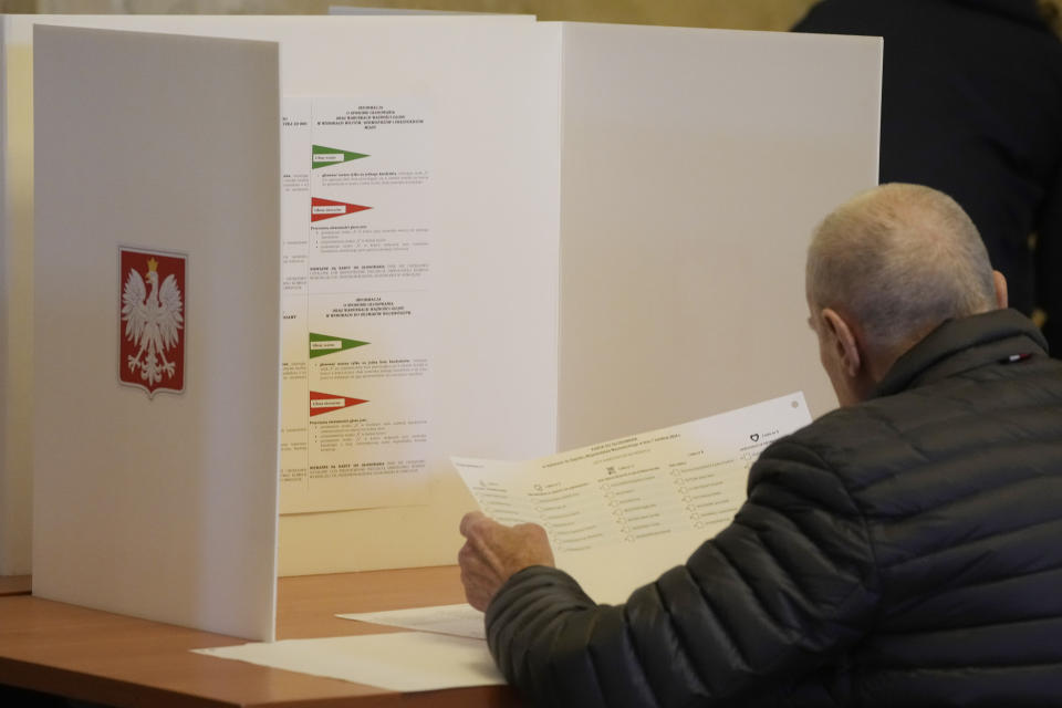 FILE - A man examines his ballot during local elections in Warsaw, Poland, Sunday, April 7, 2024. Poland’s local and regional elections on the weekend failed to give Prime Minister Donald Tusk the sweeping victory he had hoped for. (AP Photo/Czarek Sokolowski, File)