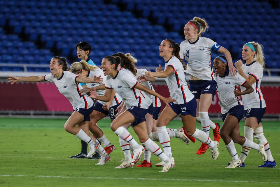 Yokohama, Japan, Friday, July 30, 2021 - USA teammates rush to congratulate Megan Rapino and Team  goalkeeper Alyssa Naeher (1) after a shootout victory over Netherlands in the Tokyo 2020 Olympics Womens Football Quarterfinal at International Stadium Yokohama. (Robert Gauthier/Los Angeles Times via Getty Images)