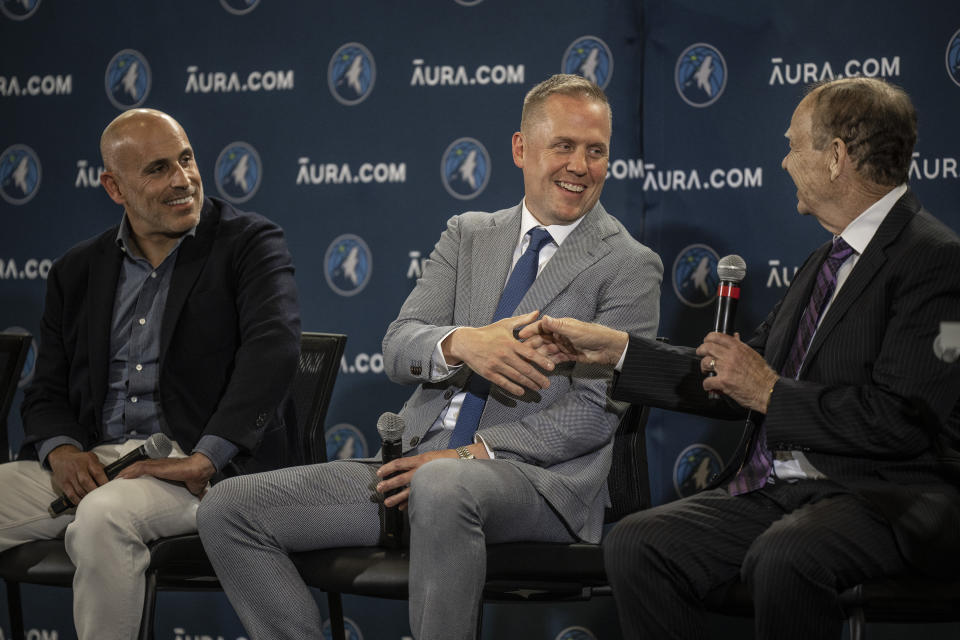 Marc Lore, left looks on as Minnesota Timberwolves new President of Basketball Operations Tim Connelly, shakes hands with team owner Glen Taylor in Minneapolis, Tuesday, May 31, 2022. (Jerry Holt/Star Tribune via AP)