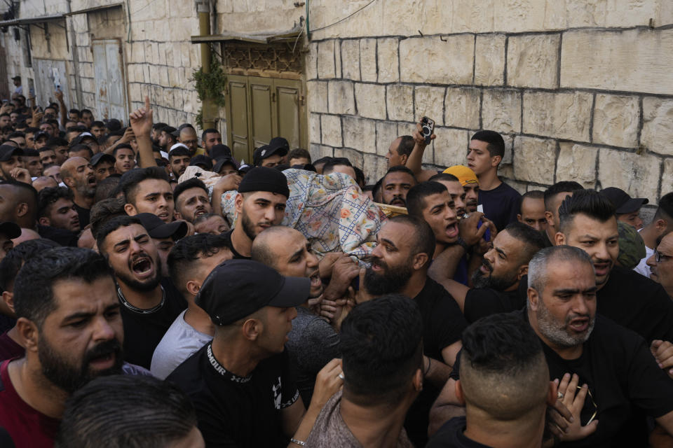 Palestinians carry the body of Islam Sabouh, who was killed during an operation by Israeli forces in the West Bank city of Nablus, Tuesday, Aug. 9, 2022. Israeli police said forces encircled the home of Ibrahim al-Nabulsi, who they say was wanted for a string of shootings in the West Bank earlier this year. They said al-Nabulsi and another Palestinian militant were killed in a shootout at the scene, and that troops found arms and explosives in his home. (AP Photo/Majdi Mohammed)