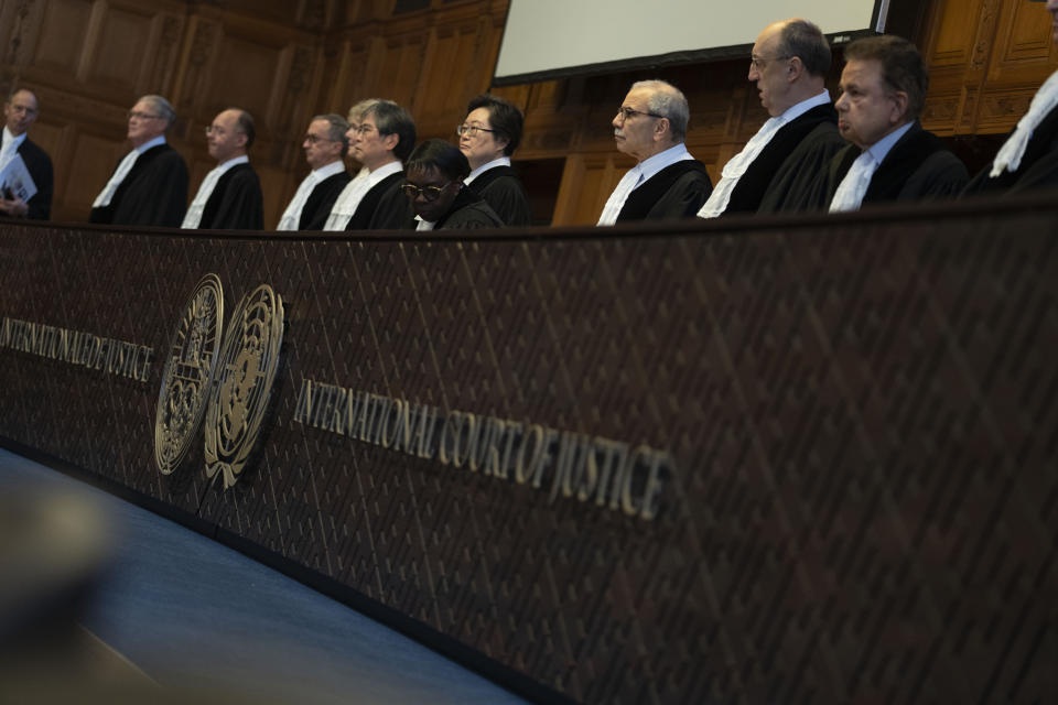 Judges enter the International Court of Justice, or World Court, in The Hague, Netherlands, Thursday, May 23, 2024. The top United Nations court is ruling Thursday on an urgent request by Mexico to order Ecuador to protect Mexican diplomatic property in the aftermath of the storming of the embassy in Quito to arrest former Vice President Jorge Glas. (AP Photo/Peter Dejong)