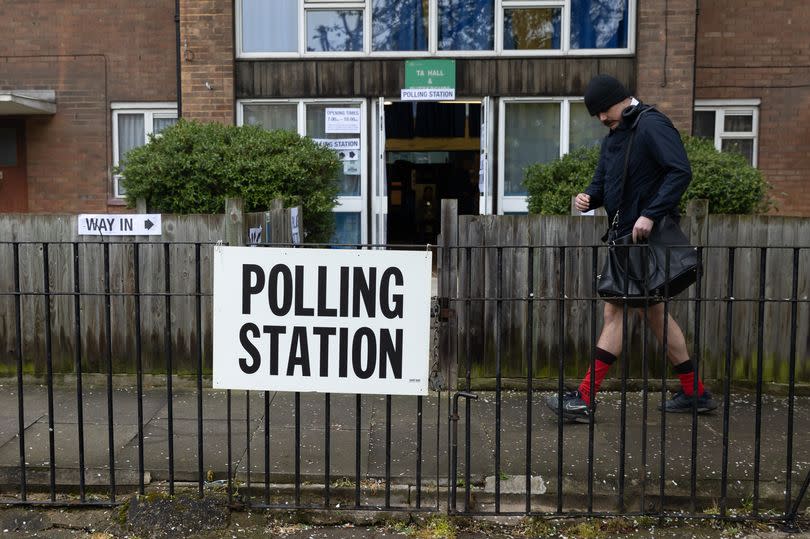 A man walks past a polling station in Kentish Town