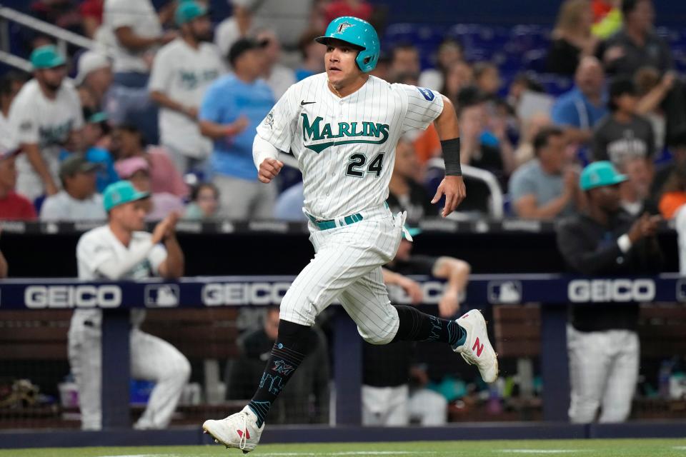 Miami Marlins' Avisail Garcia (24) runs home to score on a single by Jacob Stallings during the fourth inning of a baseball game against the Arizona Diamondbacks on April 14, 2023, in Miami.